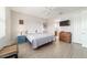 Relaxing bedroom features a ceiling fan, wood floors, and a view to the attached bathroom at 9236 Sw 91St Court Rd, Ocala, FL 34481