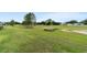 Lush green golf course with mature trees, sand trap and blue skies in the background at 9236 Sw 91St Court Rd, Ocala, FL 34481