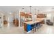 Modern kitchen featuring a blue island with seating, stainless steel appliances, and wooden cabinetry, creating a warm and inviting space at 9236 Sw 91St Court Rd, Ocala, FL 34481