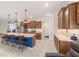 Open kitchen featuring a large island with seating, modern appliances, and wood cabinetry providing an efficient cooking space at 9236 Sw 91St Court Rd, Ocala, FL 34481