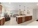 Open kitchen and living area with large island, stainless steel appliances, and neutral color palette at 9236 Sw 91St Court Rd, Ocala, FL 34481