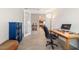 Home office with wood floors, glass doors, and a view to the kitchen and living area at 9236 Sw 91St Court Rd, Ocala, FL 34481