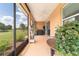Inviting screened-in porch with views of lush greenery and well maintained lawn at 9236 Sw 91St Court Rd, Ocala, FL 34481