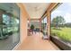 Relaxing screened-in porch featuring a ceiling fan and views of the outdoors at 9236 Sw 91St Court Rd, Ocala, FL 34481
