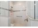 Tiled shower with bench, grab bar, and glass door at 9236 Sw 91St Court Rd, Ocala, FL 34481