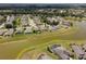 Community aerial view of the property featuring the surrounding neighborhood and landscaping by the lake at 9315 Sw 66Th Loop, Ocala, FL 34481