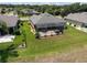 Aerial view of property showing the screen enclosed patio, well maintained lawn, and fenced in yard at 9315 Sw 66Th Loop, Ocala, FL 34481