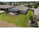 Backyard view of the property featuring a screen enclosed patio with spa and manicured lawn at 9315 Sw 66Th Loop, Ocala, FL 34481