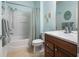 Cozy bathroom featuring a shower-tub combo, vanity with sink, and a large mirror at 9315 Sw 66Th Loop, Ocala, FL 34481