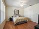 Bedroom showcasing hardwood floors, a ceiling fan, and a view of the closet and storage space at 9315 Sw 66Th Loop, Ocala, FL 34481