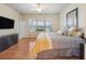 Bright bedroom with hardwood floors, ceiling fan, and sliding glass doors to a patio at 9315 Sw 66Th Loop, Ocala, FL 34481