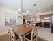 Eat-in kitchen and dining area with view to the living room and stainless steel appliances at 9315 Sw 66Th Loop, Ocala, FL 34481