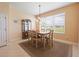 Traditional dining room featuring tile floors, stylish light fixture, and a large window at 9315 Sw 66Th Loop, Ocala, FL 34481