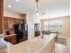 Bright kitchen with a breakfast bar, dark cabinets, and stainless-steel appliances at 9315 Sw 66Th Loop, Ocala, FL 34481