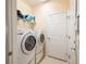 Bright laundry room with full-size washer and dryer units, shelving, and plenty of storage space at 9315 Sw 66Th Loop, Ocala, FL 34481