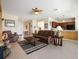 Open-concept living room with leather furniture, tile flooring, and a seamless flow into the kitchen at 9315 Sw 66Th Loop, Ocala, FL 34481