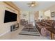 Inviting living room featuring a comfortable leather sofa, television, and a view of the front door at 9315 Sw 66Th Loop, Ocala, FL 34481