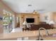 Open-concept living room with tile floors, leather furniture, and access to the patio at 9315 Sw 66Th Loop, Ocala, FL 34481