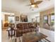 Living room with leather sofa, sliding doors to the patio, and a view into the kitchen at 9315 Sw 66Th Loop, Ocala, FL 34481