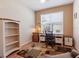 Bright office space featuring a built-in desk, chair, and bookshelf for a functional and organized workspace at 9315 Sw 66Th Loop, Ocala, FL 34481