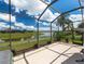 Relax on this screened patio, with views of the serene lake and lush landscaping, perfect for outdoor enjoyment at 9315 Sw 66Th Loop, Ocala, FL 34481