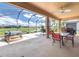 Enjoy outdoor living on the screened patio featuring a dining table, hot tub, and scenic views of the lake at 9315 Sw 66Th Loop, Ocala, FL 34481