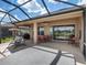Spacious screened patio with outdoor seating, a ceiling fan, and picturesque views of the green backyard at 9315 Sw 66Th Loop, Ocala, FL 34481