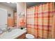 Bathroom featuring shower with decorative shower curtain, toilet, and vanity with mirror at 611 Allenwood Loop, The Villages, FL 32162