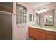 Bathroom with glass block window above vanity and a glass door shower at 611 Allenwood Loop, The Villages, FL 32162