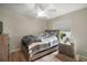 Bedroom with hardwood floors, ceiling fan, and modern furniture at 611 Allenwood Loop, The Villages, FL 32162