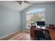 Bright bedroom features vaulted ceiling, wood floors and a large window at 611 Allenwood Loop, The Villages, FL 32162