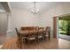 Formal dining room with wooden table set and sliding glass doors leading to the outside at 611 Allenwood Loop, The Villages, FL 32162
