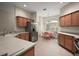 This kitchen includes stainless steel appliances, ample counter space, wood cabinets, and dining nook with natural light at 611 Allenwood Loop, The Villages, FL 32162