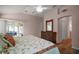 Main bedroom with wood floors, chest of drawers, and sliding doors to lanai at 611 Allenwood Loop, The Villages, FL 32162