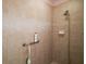 Shower stall with tile walls, handheld shower head, and grab bar at 611 Allenwood Loop, The Villages, FL 32162
