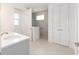 Bathroom with a vanity, tiled shower and a view through the window at 10032 Sw 85Th Place Rd, Ocala, FL 34481