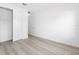 An empty room with light wood floors and a closet at 10032 Sw 85Th Place Rd, Ocala, FL 34481