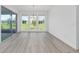 Bright dining room featuring recessed lighting, light wood flooring, and a large glass door at 10032 Sw 85Th Place Rd, Ocala, FL 34481