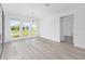 Dining room featuring light wood floors, a modern chandelier, and large glass windows at 10032 Sw 85Th Place Rd, Ocala, FL 34481