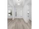 Bright foyer with wood-look flooring, showcasing an open view and pristine white walls at 10032 Sw 85Th Place Rd, Ocala, FL 34481