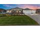 Beautiful one-story home with well-manicured lawn and a three-car garage and stone accents on the columns at 10032 Sw 85Th Place Rd, Ocala, FL 34481