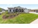 Charming single-story home with a manicured lawn, stone column accents, and inviting curb appeal at 10032 Sw 85Th Place Rd, Ocala, FL 34481