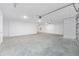 Unfinished two car garage with concrete floors and an automatic garage door at 10032 Sw 85Th Place Rd, Ocala, FL 34481