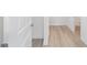 Hallway featuring wood-look floors, white doors, and trim at 10032 Sw 85Th Place Rd, Ocala, FL 34481