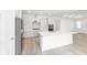 Bright kitchen featuring white cabinets, mosaic backsplash, stainless appliances, and an island with quartz countertops at 10032 Sw 85Th Place Rd, Ocala, FL 34481