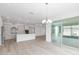 Open-concept kitchen featuring white cabinets, stainless steel appliances, and a large island perfect for entertaining at 10032 Sw 85Th Place Rd, Ocala, FL 34481