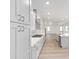 Modern kitchen featuring white cabinets, stainless steel appliances, and an open floor plan at 10032 Sw 85Th Place Rd, Ocala, FL 34481