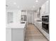 Modern kitchen boasting white cabinets, stone counters, and stainless steel appliances at 10032 Sw 85Th Place Rd, Ocala, FL 34481