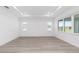 A bright living room featuring light wood floors and many windows at 10032 Sw 85Th Place Rd, Ocala, FL 34481