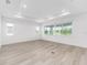 Bright living room with light wood floors, recessed lighting and many windows at 10032 Sw 85Th Place Rd, Ocala, FL 34481